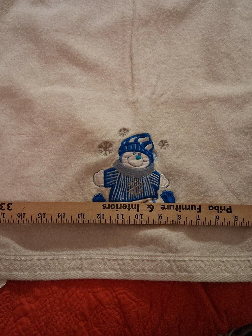 White Bath Towel With A Snowman Design On It